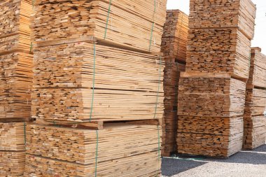 Stacks of lumber stacked and tied in warehouse