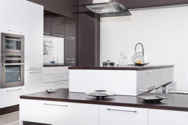 modern kitchen with white and black walls and a large glass