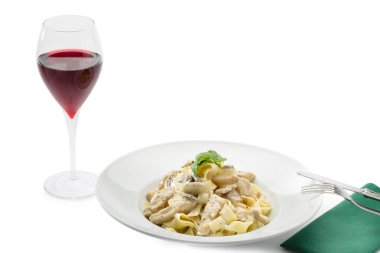 Pasta with cheese sauce, accompanied by a glass of red wine