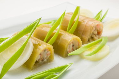 Stuffed zucchini with olive oil on a white plate