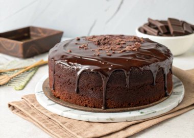 Beyaz tabakta karamel kaplı çikolatalı pasta.
