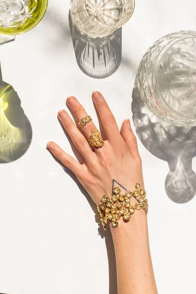 woman hand wearing jewelry, glass shades