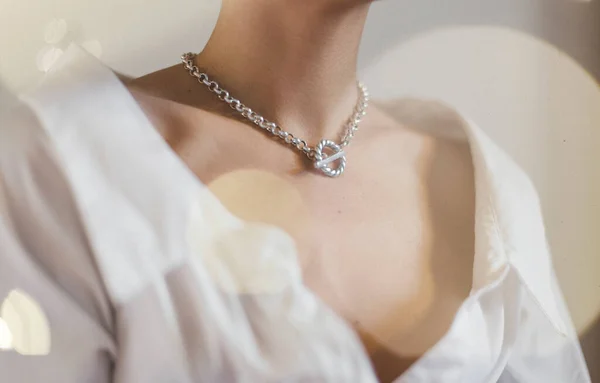 detail of a beautiful neck wearing jewelery