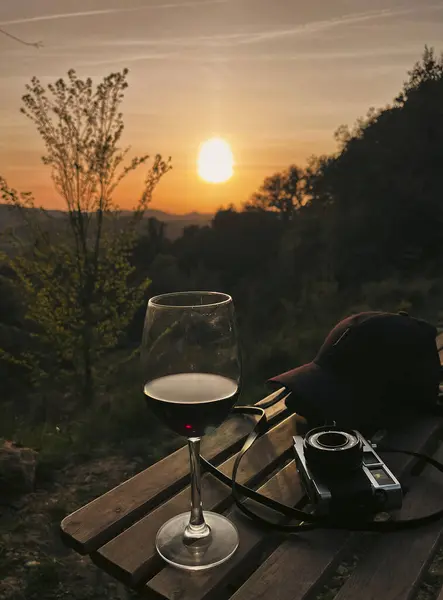 stock image enjoying a cup of red wine in a beautiful sunset