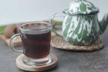 Traditional Javanese tea served with palm sugar for a sweet, creamy flavor. Enjoy the authentic taste of Indonesia in every sip. Closeup