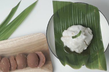 Bubur sum sum or Bubur merah putih.Traditional Indonesian dessert made from sweet glutinous rice, coconut milk, and pandanus leaf, topped with a sprinkle of red and white sugar.