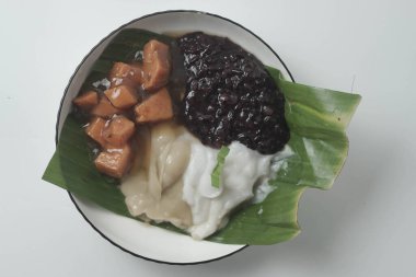 Bubur sum sum or Bubur merah putih.Traditional Indonesian dessert made from sweet glutinous rice, coconut milk, and pandanus leaf, topped with a sprinkle of red and white sugar.