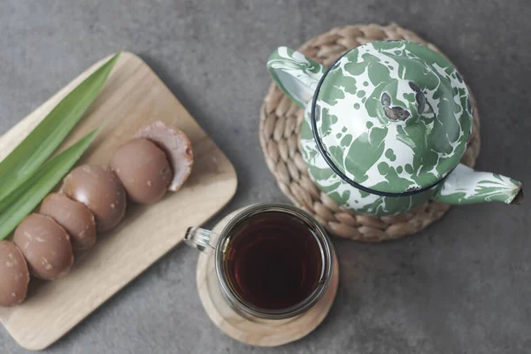 Traditional Javanese tea served with palm sugar for a sweet, creamy flavor. Enjoy the authentic taste of Indonesia in every sip. Closeup