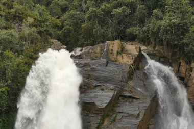 A beautiful rock waterfall against the background of a tropical forest