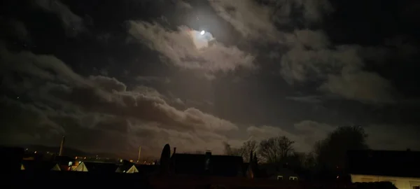 cloudy sky at night over a small town