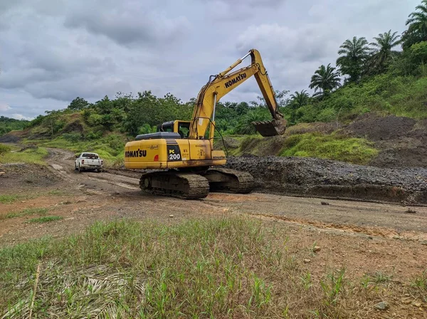 excavator is working on dirt road