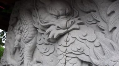 Close-up on a dragon relief at a hidden Buddhist stupa