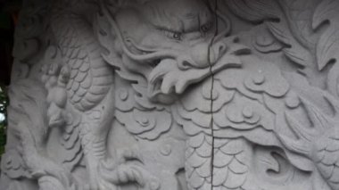 Close-up on a dragon relief at a hidden Buddhist stupa