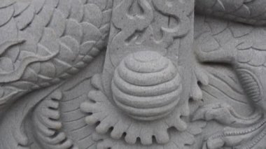 Close-up on a dragon relief at a hidden Buddhist stupa