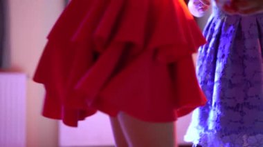 Girls in skirts dancing at a party