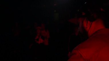 Bearded DJ on stage from behind