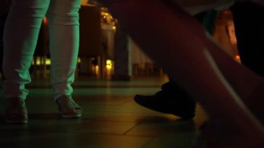 Groom dancing in socks at a wedding party