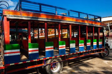 Colorful traditional rural bus from Colombia called chiva clipart