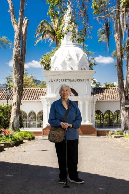 Senior woman tourist at the beautiful heritage town of Salamina in the department of Caldas in Colombia clipart