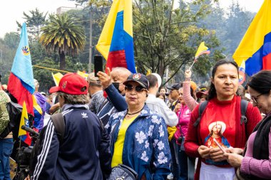 BOGOTA, COLOMBIA - 21 April 2024. March asking for Gustavo Petro impeachment. Peaceful protest march in Bogota Colombia against the law reforms of Gustavo Petro government. clipart