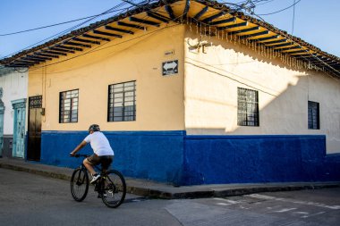 SALAMINA, COLOMBIA - 13 HAZİRAN 2024: Kolombiya 'nın Caldas bölgesinde yer alan tarihi şehir Salamina' nın güzel sokaklarında bisikletçi.