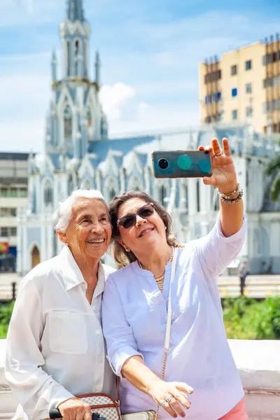 stock image Senior mother and daugther travelling togeher having fun. Senior adults in Cali Colombia. Senior lifestyle. Senior travel.