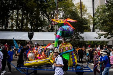 Mexico City, Mexico - October 19, 2024: Traditional parade of the colorful imaginary creatures called Alebrijes at the Reforma Street in Mexico City. clipart