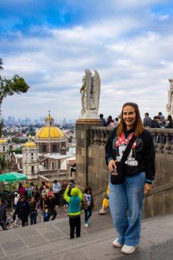 Mexico City, Mexico - October 27, 2024: Female tourist at the Stairs leading up to Tepeyac Hill. Basilica of Guadalupe. clipart