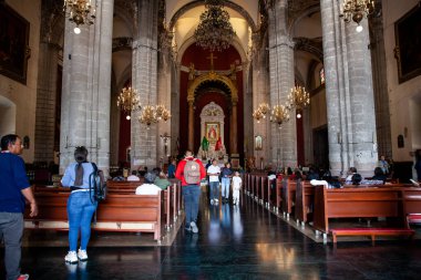 Mexico City, Mexico - September 16, 2024: Pilgrims at the Old Basilica of Guadalupe known as Expiatory Temple of Christ the King in Mexico City. clipart