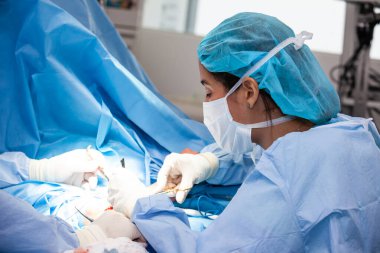 Kadın bir doktor ameliyat yapıyor. Ortopedik cerrah. Ameliyat ve sigorta konsepti.