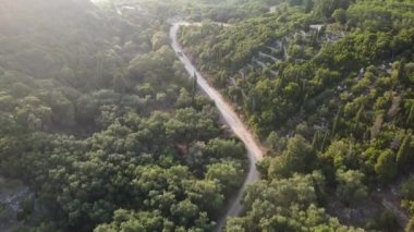 Chasing the car over lush green vegetation and green terraces on the Island of Corfu, Greece