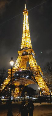 the eiffel tower of paris at sunset with beautiful lights of night