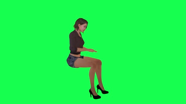 穿着棕色衣服 黑色短裤和高跟鞋的年轻欧洲女人从左角在绿色荧幕上赌博 — 图库视频影像