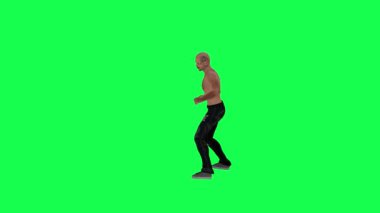 Yeşil ekran üzerinde atletik bir vücudu olan, saçları ve vücudu olmayan, siyah pantolonu kahverengi ayakkabılı, koyu tenli, bıyıklı, sakallı ve şakağında dövmesi olan bir adam.