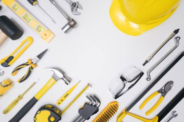 Top view flat lay construction tools  safety equipment on white background for diy built or repair in workshop.