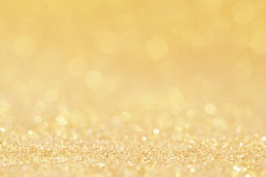Noel altın parıltılı parıltılı parıltısı soyut arkaplanı bulanıklaştırıyor. Noel xmas ve mutlu yeni yıl arkaplanı fikri, lüks duvar kâğıdı..
