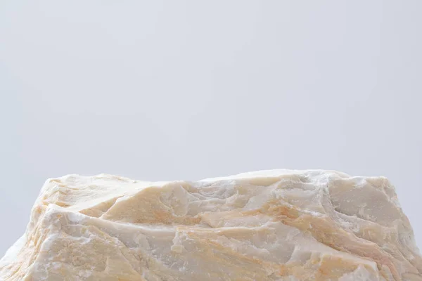 empty natural rough beige granite stone podium on white background with blank space.cosmetic beauty fashion product present placement pedestal promotion display,mock up minimal concept.