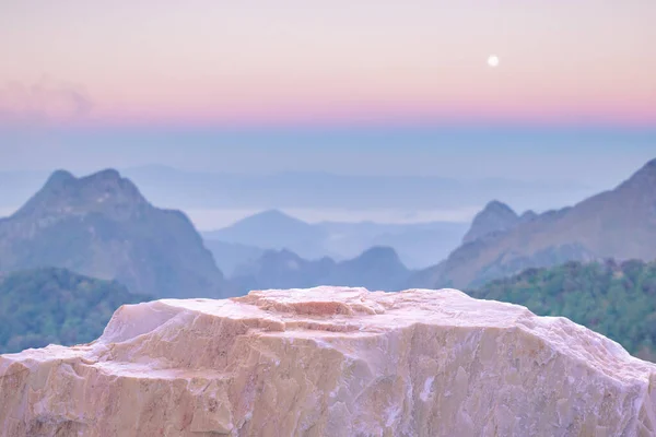 Stone podium table top with outdoor mountains pastel color scene nature landscape at sunrise blur background.Natural beauty cosmetic or healthy product placement presentation pedestal display.