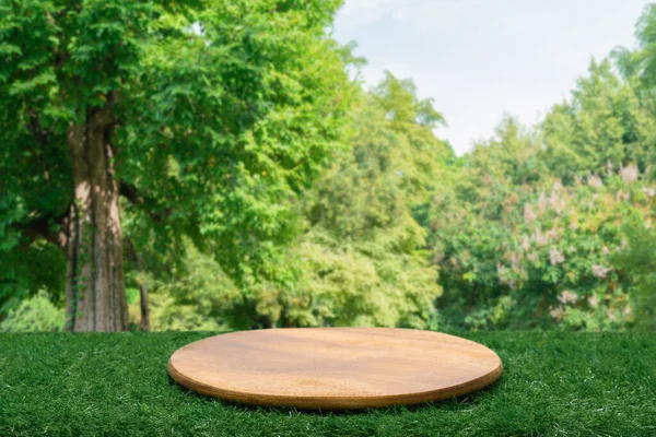 Wood tabletop podium floor in outdoors green leaf tropical forest nature landscape background.Organic healthy natural product present placement pedestal counter display,spring summer jungle concept.