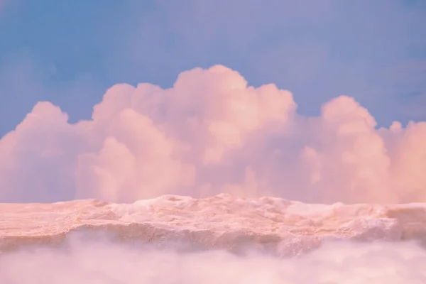 Surreal stone podium outdoors on clouds in soft blue sky pink pastel misty mountain nature landscape.Beauty cosmetic product placement pedestal present display,spring summer paradise dreamy concept.