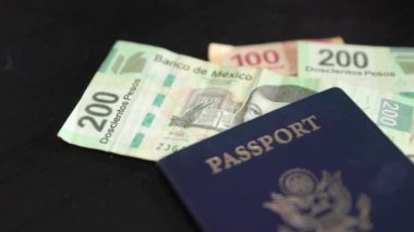 American passport with Mexican money ready to use when traveling to Mexico