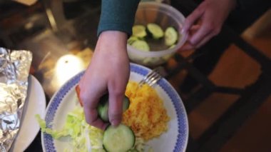 Salmon, rice, cabbage, and cucumber salad on a large plate for dinner
