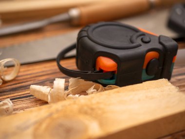 Joinery table with boards, wood chips  and tape measure