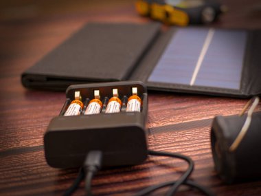 Atmospheric composition on the theme of charging gadgets: battery charging and solar panel