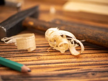Carpentry and a hammer. Atmospheric composition about carpentry with planks, shavings, and joinery tools