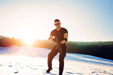 Winter arctic mountains warfare. Action in cold conditions. soldier with weapons in forest somewhere above the Arctic Circle