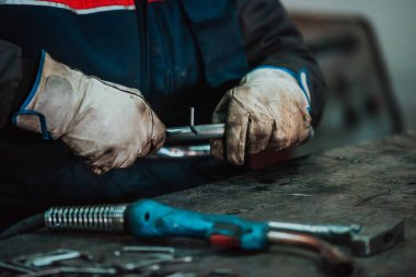 A worker in an industry preparing iron structures for welding. 