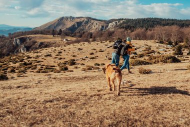 a young couple hiking having fun on the mountain