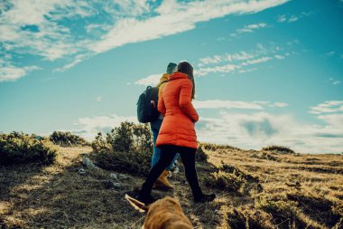 two friends are walking in nature and enjoying a beautiful sunny day