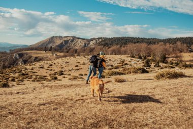 a young couple hiking having fun on the mountain